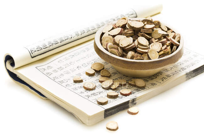 Medicina tradicional chinesa, gengibre seco em tigela no livro médico antigo — Fotografia de Stock