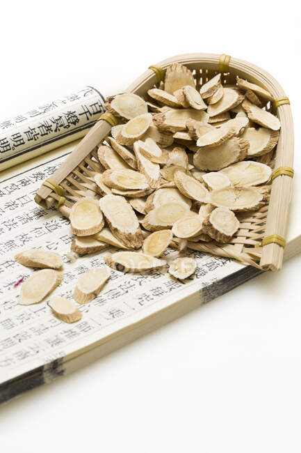 Traditional Chinese medicine, dried ginger and ancient medical book — Stock Photo