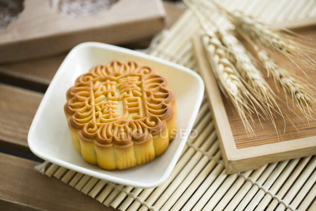 Chinese traditional Mooncake on wooden plate — Stock Photo