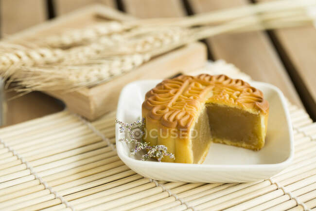 Mooncake with missing piece served on plate — Stock Photo