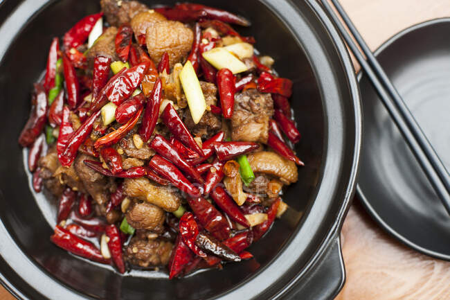 Chinese cuisine, beef with chili in bowl, close up shot — Stock Photo