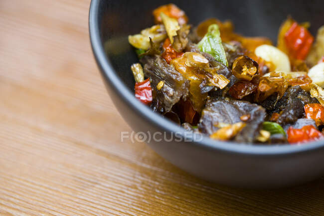 Beef with chili pepper in bowl, close up shot — Stock Photo