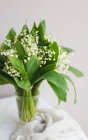 Blooming spring flowers in vase on table. Closeup photo — Stock Photo
