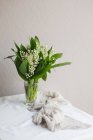 Blooming spring flowers in vase on table. Closeup photo — Stock Photo