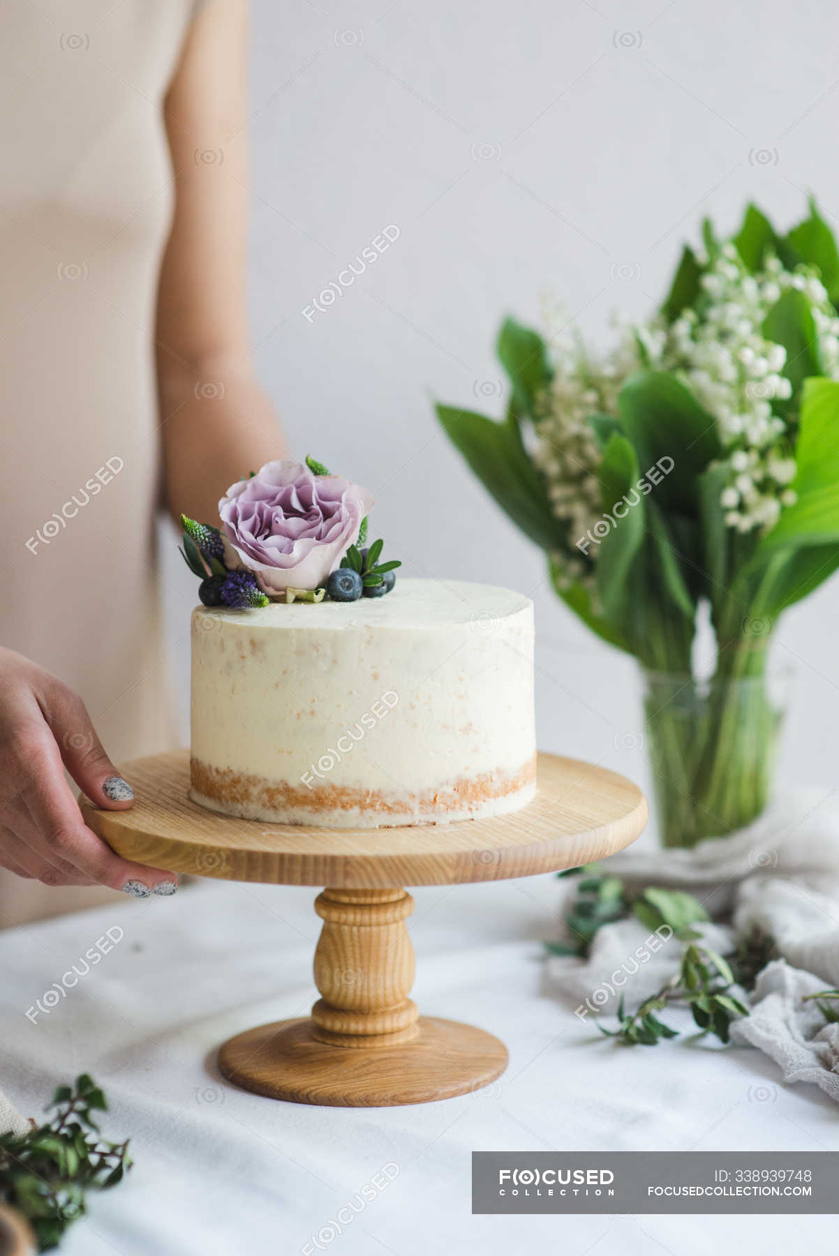Pastry chef preparing naked wedding birthday cake. Candy maker ...