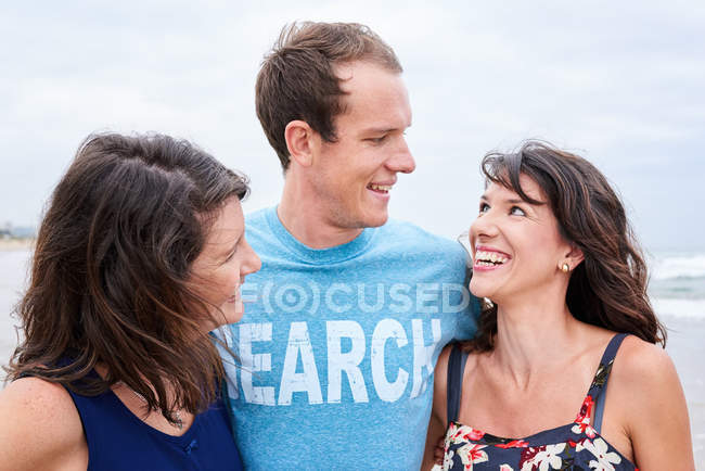 Three siblings laughing and smiling at each other — Stock Photo