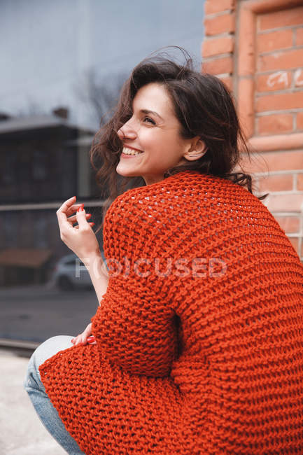 Woman wearing knitted colorful coat outdoor — Stock Photo