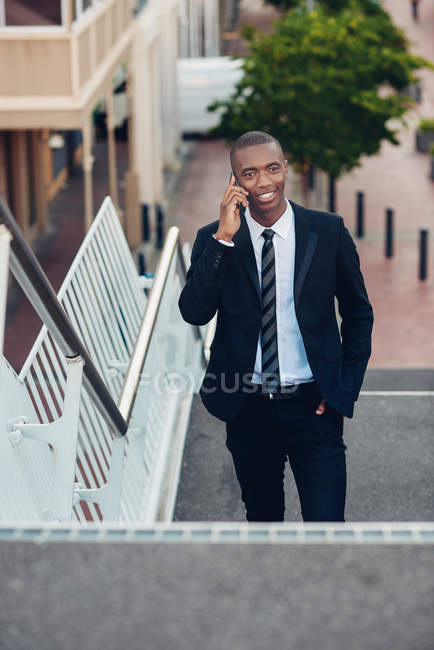 Businessman walking up on stairs — Stock Photo