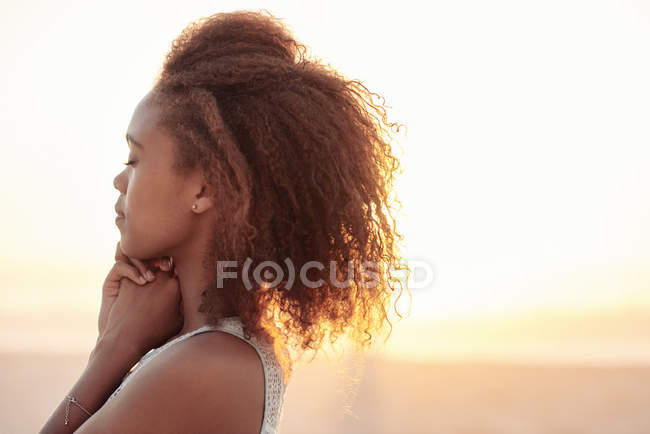 Жінка з закритими очима на пляжі в сутінках — стокове фото