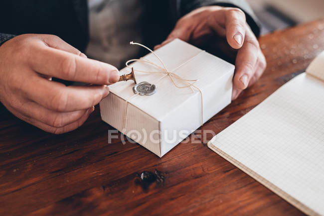 Unternehmer stempelt Siegel auf Paket zur Auslieferung — Stockfoto