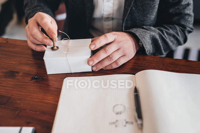 Unternehmer stempelt Siegel auf Paket zur Auslieferung — Stockfoto