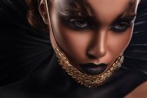 Portrait of woman with fantasy makeup and accessory on chin — Stock Photo