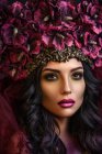 Portrait of woman wearing large floral crown — Stock Photo