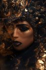 Close up shot of woman with fantasy makeup wearing crown — Stock Photo