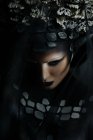 Portrait of woman with fantasy makeup wearing crown — Stock Photo