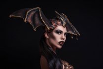 Woman with fashion makeup wearing dragon style crown — Stock Photo