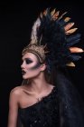 Woman with fashion makeup wearing feathers crown — Stock Photo