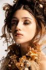 Attractive fashionable woman with golden makeup and wreath — Stock Photo
