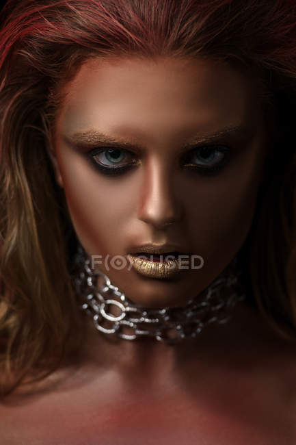 Portrait of woman with fantasy makeup looking at camera — Stock Photo