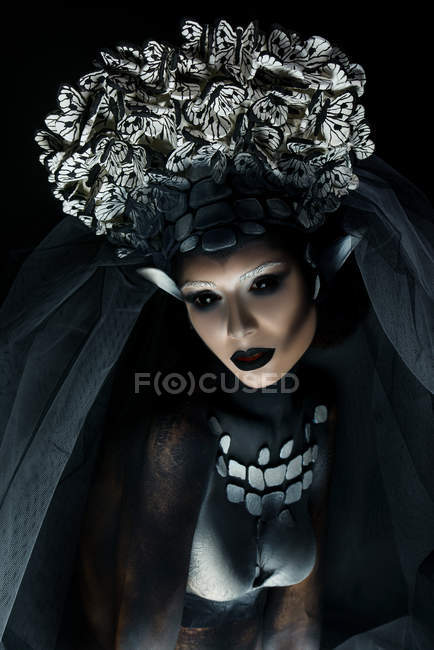 Mulher com maquiagem fantasia vestindo grande coroa e posando na câmera — Fotografia de Stock