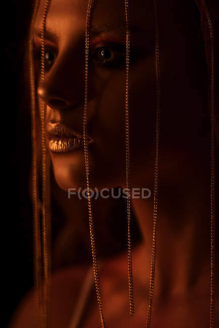 Portrait of woman with fantasy makeup and chain on face — Stock Photo