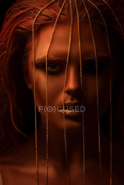 Portrait of woman with fantasy makeup and chain on face — Stock Photo