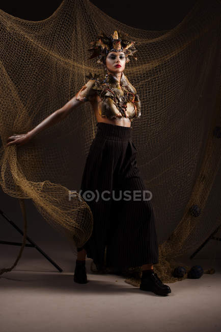 Monster with headdress and clothes made from fishes — Stock Photo
