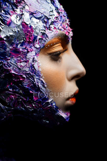 Young beautiful woman with creative make up and fancy costume posing — Stock Photo