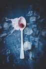 Spoon with raspberry and ice cream — Stock Photo