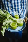 Fresh kale leaves and green smoothie — Stock Photo