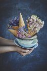Bowls with waffle cones and flowers — Stock Photo