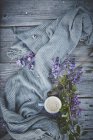 Tasse mit Kaffee und schönen Blumen — Stockfoto