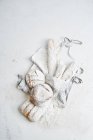Loaves of bread on apron in flour — Stock Photo
