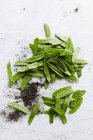 Green peas pods and soil — Stock Photo