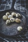 Quail eggs in shells on frying pan — Stock Photo