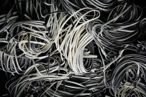 Heap of black and white pasta — Stock Photo
