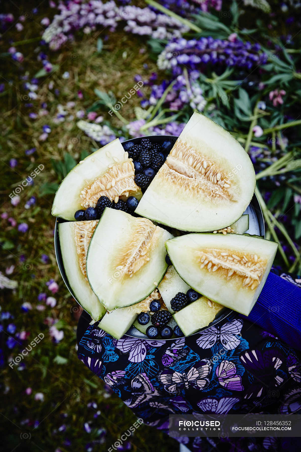 Fresh sliced melons and berries — healthy, clean Stock Photo 128456352