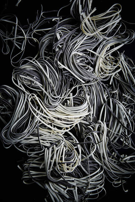 Heap of black and white pasta — Stock Photo