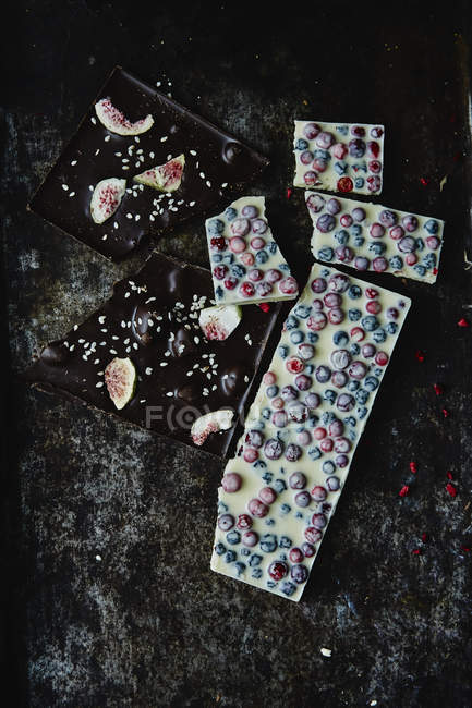 Chocolate pieces with nuts and berries — Stock Photo