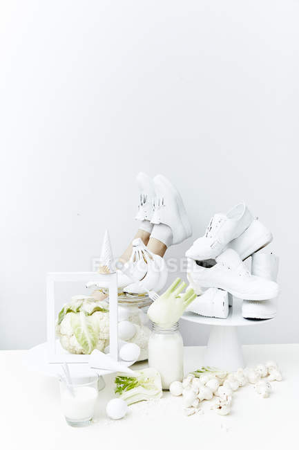 Female legs and healthy white ingredients — Stock Photo