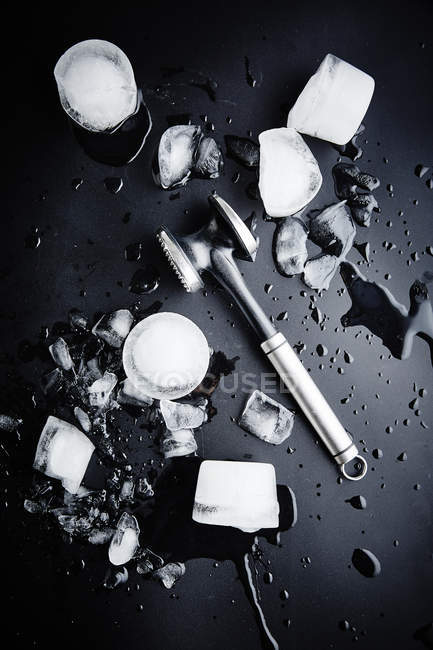 Ice cubes and ice hammer — Stock Photo