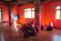 Young monks sitting inside temple — Stock Photo