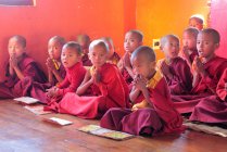 Young novice monks looking at camera — Stock Photo