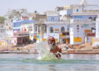 Indian poor man taking bath — Stock Photo