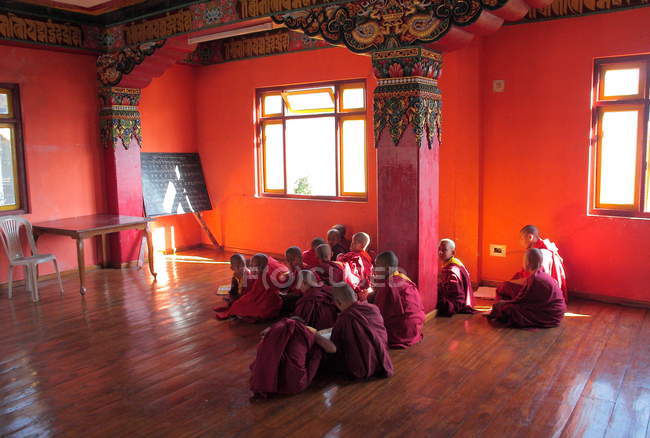 Молодые монахи сидят внутри храма — стоковое фото