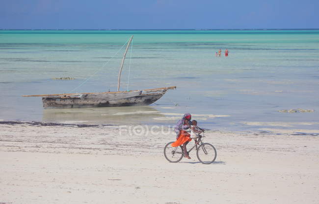 Family Riding Bike on the beach Zanzibar — Stock Photo