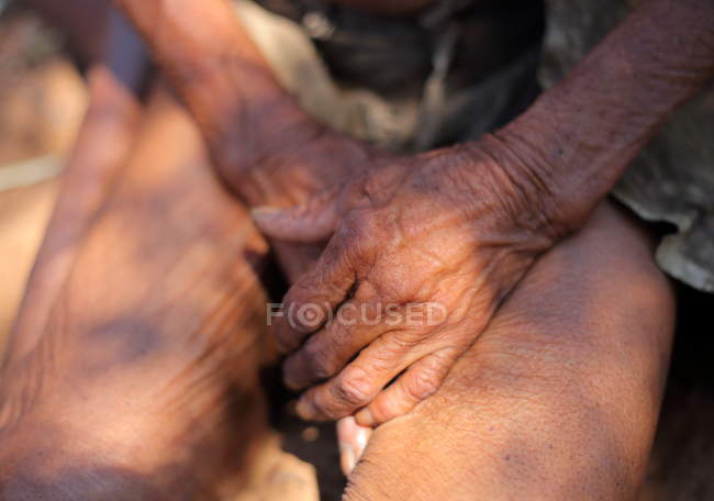 Hands of old person in village — Stock Photo