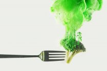 Broccoli on fork on white — Stock Photo