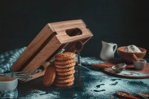 Cookies under a wooden box trap — Stock Photo