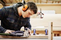 Young man using tools — Stock Photo